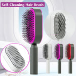 Close-up of a woman pressing the button on the back of a white self-cleaning hair brush to pop out trapped hair